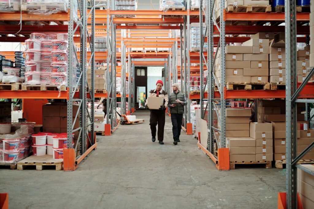 Warehouse team managing packages and inventory shelves for logistics supply chain