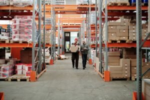 Warehouse team managing packages and inventory shelves for logistics supply chain